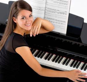 woman smiling sitting at the piano